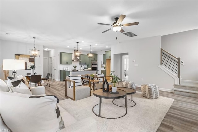 MM SC, Chesapeake, VA 23322 - living room with light wood-style flooring, recessed lighting, a ceiling fan, stairway, and baseboards