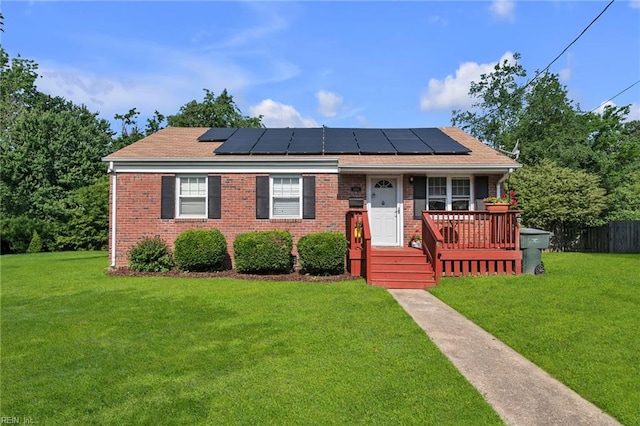 6413 Natrona Ave, Norfolk, VA 23509 - view of front facade featuring roof mounted solar panels and brick siding