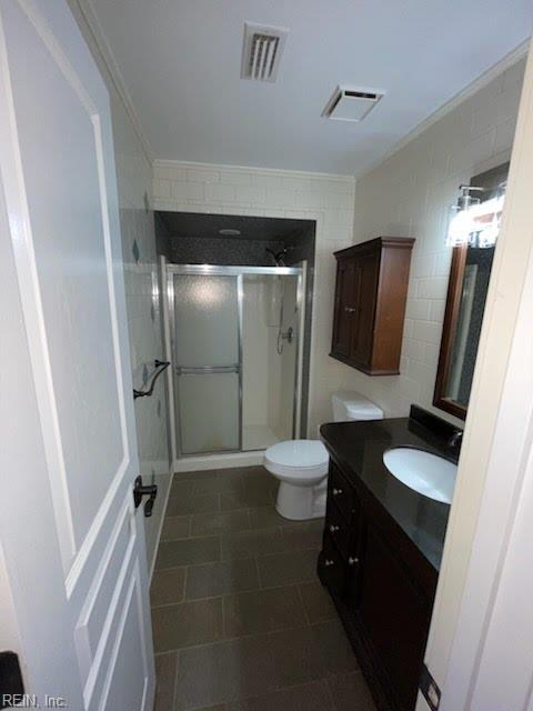 1496 Morgan Dr, Hampton, VA 23663 - bathroom with vanity, a shower stall, toilet, and ornamental molding