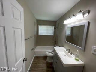 1496 Morgan Dr, Hampton, VA 23663 - bathroom featuring toilet, wood finished floors, vanity, a shower, and baseboards
