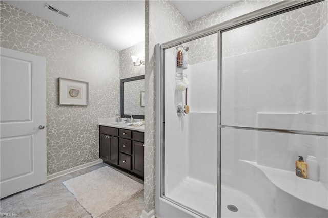 1720 Vankar Dr, Virginia Beach, VA 23456 - bathroom with a shower stall, double vanity, wallpapered walls, and a textured ceiling