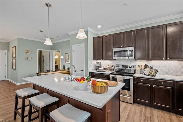 1720 Vankar Dr, Virginia Beach, VA 23456 - kitchen featuring stainless steel appliances, a sink, a breakfast bar area, light wood-style flooring, and crown molding