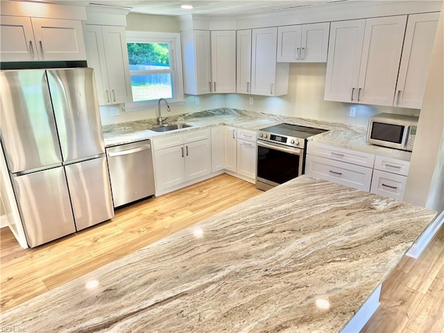 1813 Jack Frost Rd, Virginia Beach, VA 23455 - kitchen featuring stainless steel appliances, a sink, light wood-type flooring, light stone countertops, and white cabinets