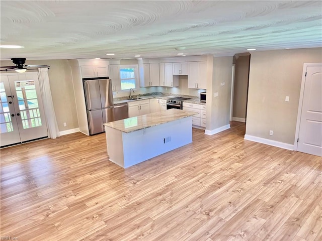 1813 Jack Frost Rd, Virginia Beach, VA 23455 - kitchen with stainless steel appliances, a sink, baseboards, a center island, and light stone counters