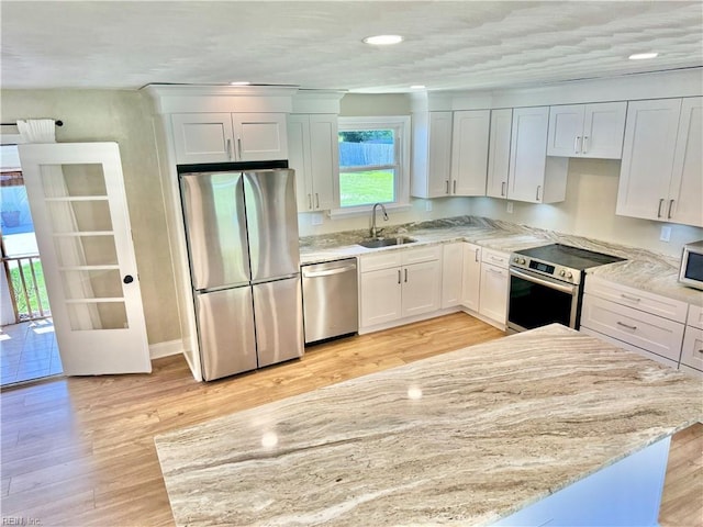 1813 Jack Frost Rd, Virginia Beach, VA 23455 - kitchen featuring appliances with stainless steel finishes, a sink, light stone counters, light wood-style floors, and recessed lighting