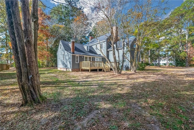 221 Homestead Rd, Franklin, VA 23851 - back of property with a deck, a chimney, and a yard