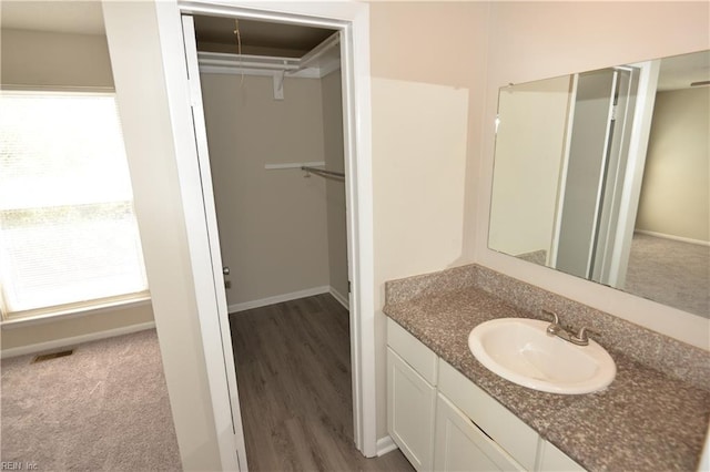 3861 Chancery Ln, Virginia Beach, VA 23452 - bathroom with a spacious closet, vanity, wood finished floors, and baseboards