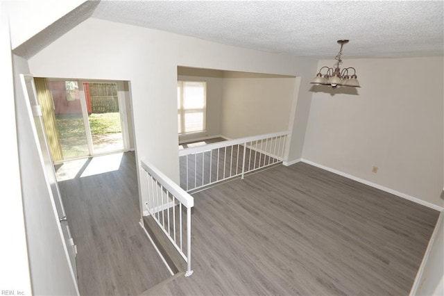 3861 Chancery Ln, Virginia Beach, VA 23452 - unfurnished room featuring wood finished floors, a textured ceiling, a chandelier, and baseboards