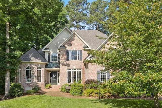 20524 Creekside Dr, Smithfield, VA 23430 - view of front of property with brick siding, a front yard, and a shingled roof
