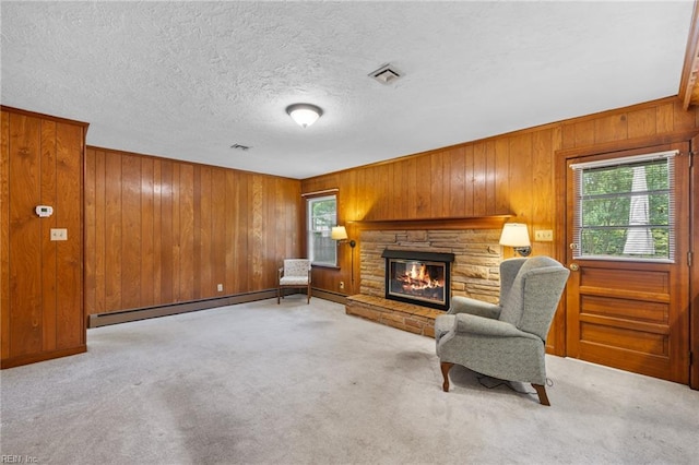 4422 Gannon Rd, Portsmouth, VA 23703 - sitting room with a baseboard heating unit, wooden walls, a fireplace, carpet floors, and a textured ceiling