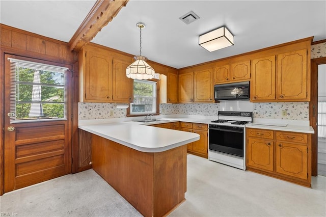 4422 Gannon Rd, Portsmouth, VA 23703 - kitchen with range with gas cooktop, black microwave, a sink, a peninsula, and healthy amount of natural light