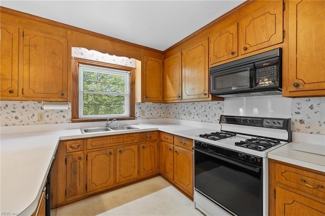 4422 Gannon Rd, Portsmouth, VA 23703 - kitchen featuring black microwave, gas range, a sink, and brown cabinetry