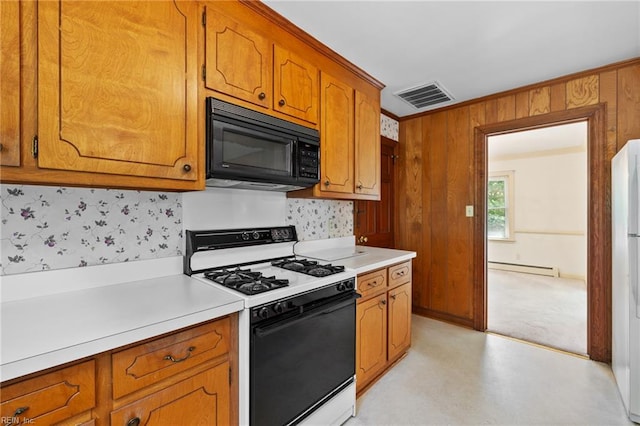 4422 Gannon Rd, Portsmouth, VA 23703 - kitchen with black microwave, gas range, light countertops, brown cabinets, and wooden walls