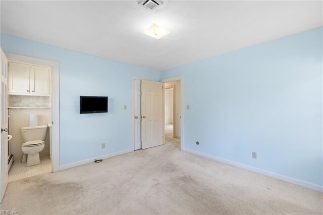 4422 Gannon Rd, Portsmouth, VA 23703 - unfurnished bedroom with baseboards, a baseboard heating unit, light carpet, and ensuite bath