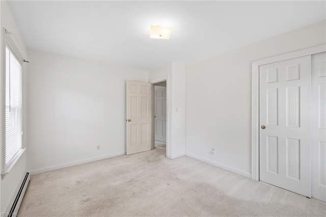 4422 Gannon Rd, Portsmouth, VA 23703 - unfurnished bedroom with a baseboard radiator, light colored carpet, multiple windows, and baseboards