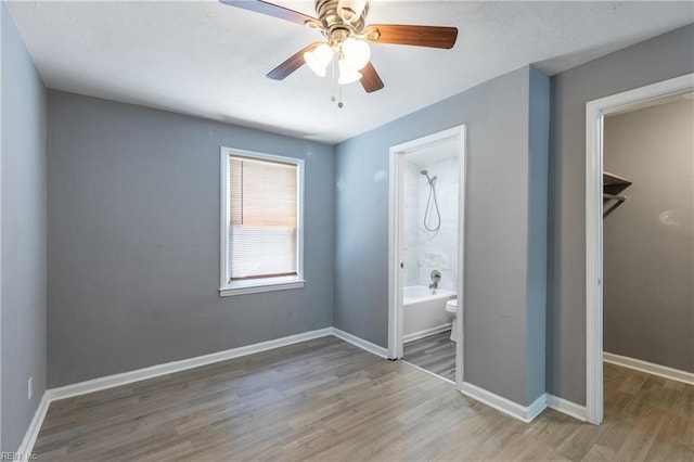 624 Highland Ct, Newport News, VA 23605 - unfurnished bedroom featuring wood finished floors, baseboards, ensuite bathroom, and a ceiling fan