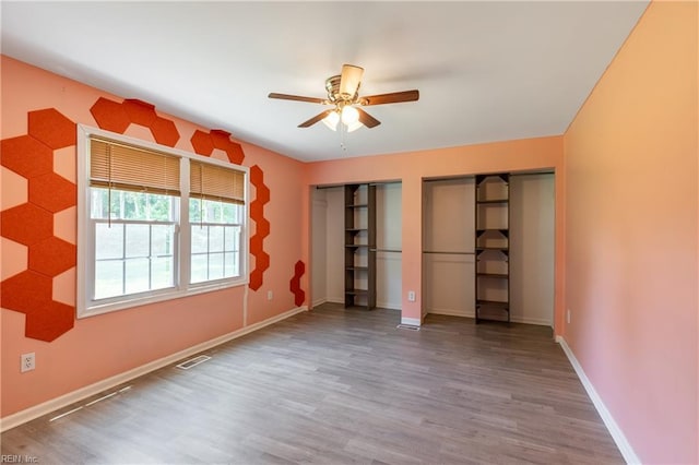 624 Highland Ct, Newport News, VA 23605 - unfurnished bedroom featuring two closets, wood finished floors, baseboards, and ceiling fan