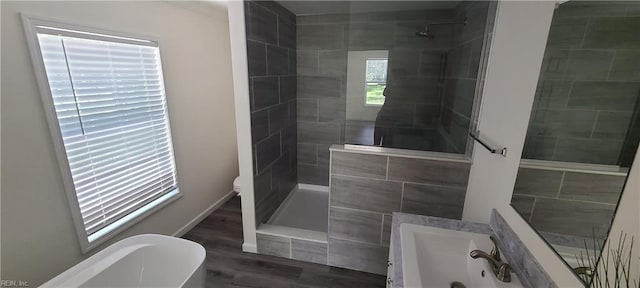 175 Pinto Dr, Moyock, NC 27958 - bathroom with a tile shower, a freestanding bath, wood finished floors, baseboards, and toilet