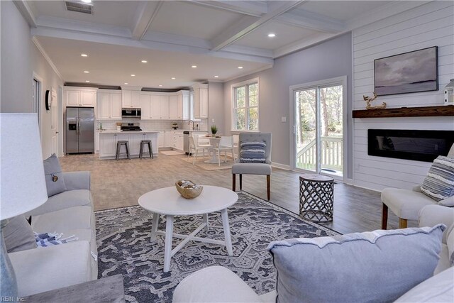 718C Poquoson Ave, Poquoson, VA 23662 - living area featuring light wood-type flooring, beamed ceiling, crown molding, recessed lighting, and a fireplace