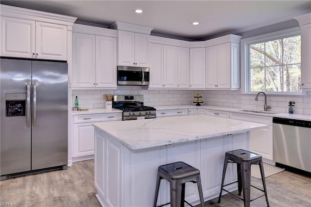 718C Poquoson Ave, Poquoson, VA 23662 - kitchen with stainless steel appliances, a sink, a center island, white cabinets, and recessed lighting
