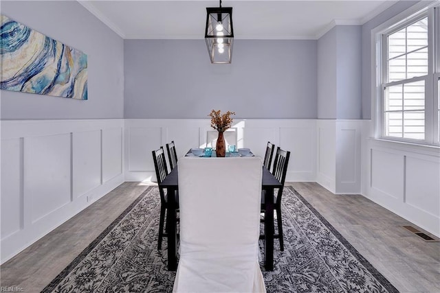 718C Poquoson Ave, Poquoson, VA 23662 - dining room with wood finished floors, a decorative wall, ornamental molding, and a wainscoted wall