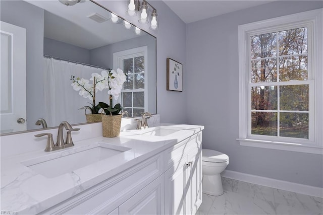 718C Poquoson Ave, Poquoson, VA 23662 - bathroom with toilet, double vanity, marble look tiles, and baseboards