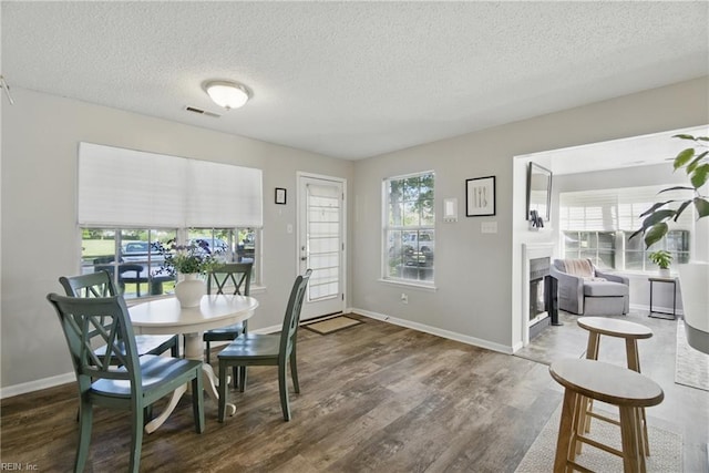 5165 Thatcher Way, Virginia Beach, VA 23456 - dining room with a fireplace, a textured ceiling, wood finished floors, and baseboards