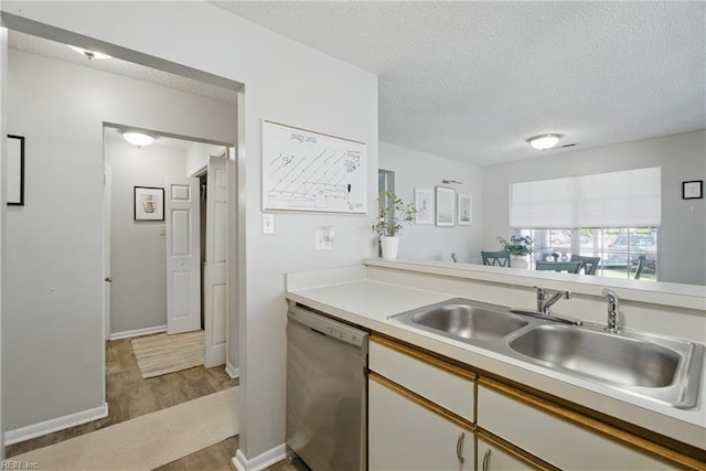 5165 Thatcher Way, Virginia Beach, VA 23456 - kitchen featuring dishwasher, a sink, wood finished floors, light countertops, and a textured ceiling