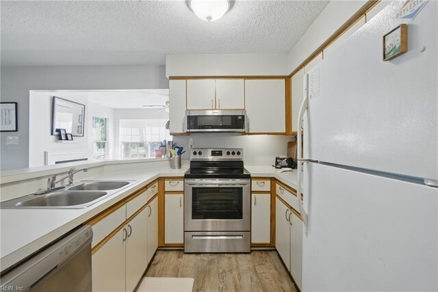 5165 Thatcher Way, Virginia Beach, VA 23456 - kitchen featuring stainless steel appliances, a sink, light wood finished floors, light countertops, and a textured ceiling