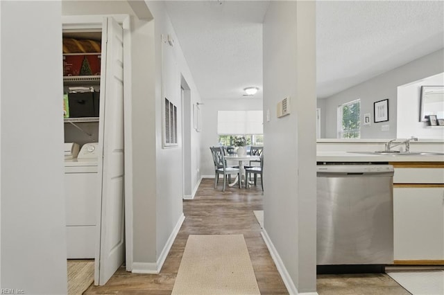 5165 Thatcher Way, Virginia Beach, VA 23456 - hallway featuring washer and dryer, a sink, light wood-style flooring, a textured ceiling, and baseboards