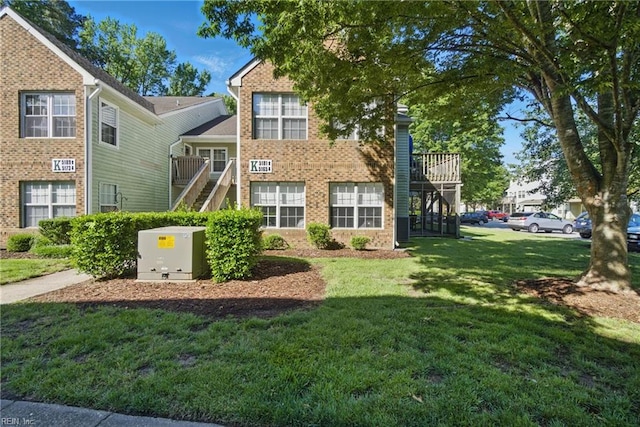 5165 Thatcher Way, Virginia Beach, VA 23456 - view of front facade with stairway, brick siding, and a front yard