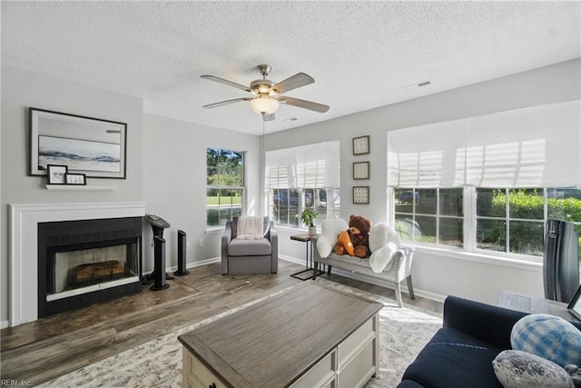5165 Thatcher Way, Virginia Beach, VA 23456 - living room with wood finished floors, ceiling fan, a textured ceiling, baseboards, and a fireplace