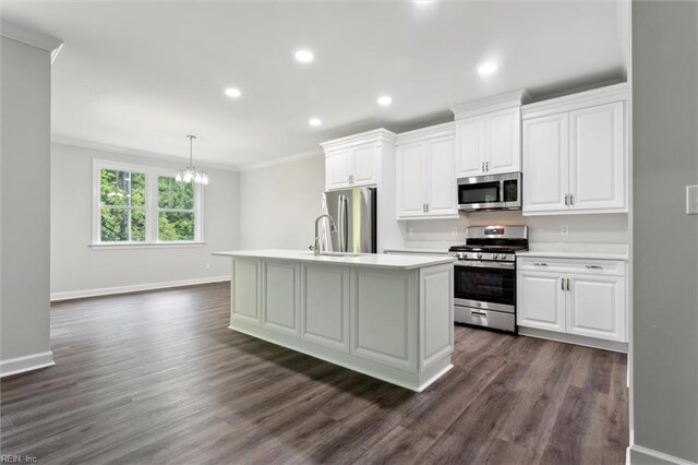 206 Loon Ct, Newport News, VA 23606 - kitchen with stainless steel appliances, ornamental molding, light countertops, baseboards, and a center island with sink