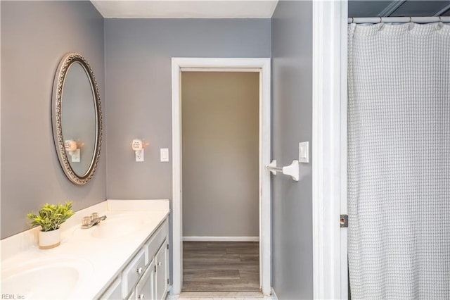 2668 N Elizabeth Harbor Dr, Chesapeake, VA 23321 - bathroom featuring double vanity, wood finished floors, baseboards, and a shower with shower curtain