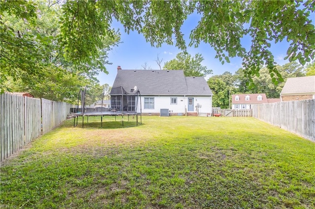 2668 N Elizabeth Harbor Dr, Chesapeake, VA 23321 - back of house featuring a trampoline, central AC unit, and a chimney