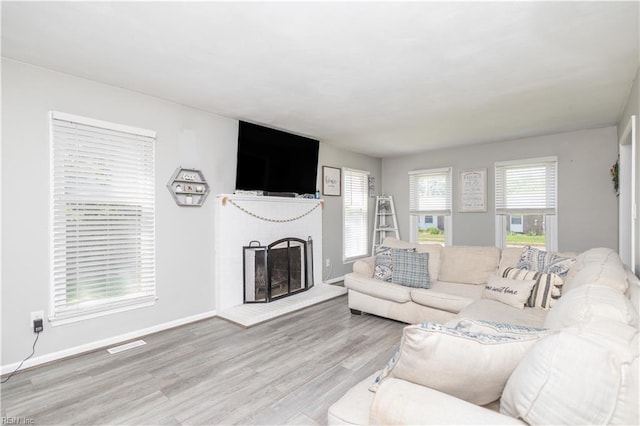 2668 N Elizabeth Harbor Dr, Chesapeake, VA 23321 - living room featuring wood finished floors, a brick fireplace, and baseboards