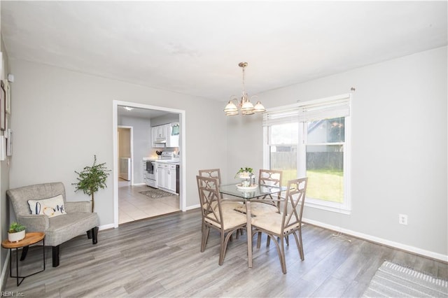 2668 N Elizabeth Harbor Dr, Chesapeake, VA 23321 - dining room with a chandelier, light wood-type flooring, and baseboards