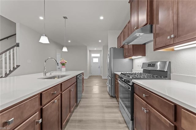 23050 Preserve Pl, Carrollton, VA 23314 - kitchen featuring appliances with stainless steel finishes, under cabinet range hood, a sink, light countertops, and recessed lighting