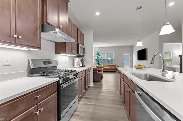 23050 Preserve Pl, Carrollton, VA 23314 - kitchen with stainless steel appliances, under cabinet range hood, a sink, light countertops, and recessed lighting