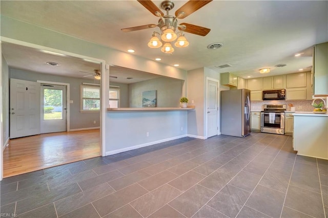529 Warren Ave, Chesapeake, VA 23322 - kitchen featuring appliances with stainless steel finishes, ceiling fan, light countertops, baseboards, and tasteful backsplash