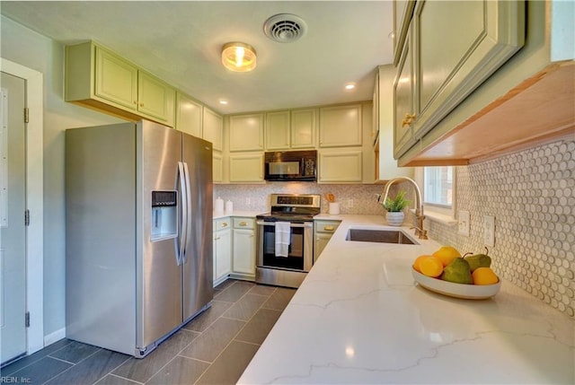 529 Warren Ave, Chesapeake, VA 23322 - kitchen featuring appliances with stainless steel finishes, a sink, tasteful backsplash, and light stone counters