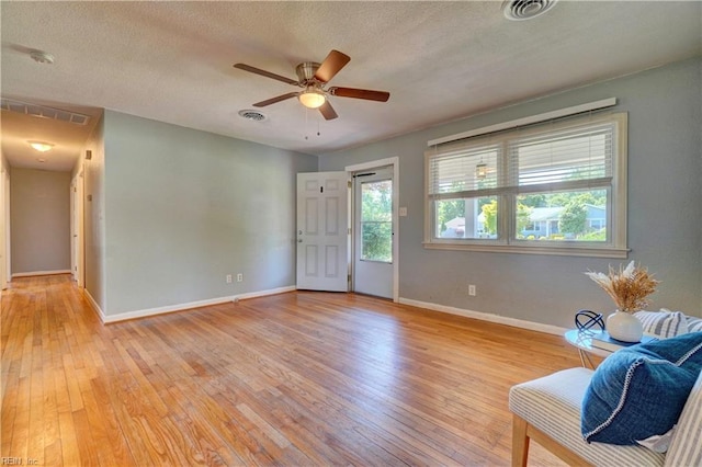 529 Warren Ave, Chesapeake, VA 23322 - living area featuring light wood finished floors, baseboards, ceiling fan, and a textured ceiling