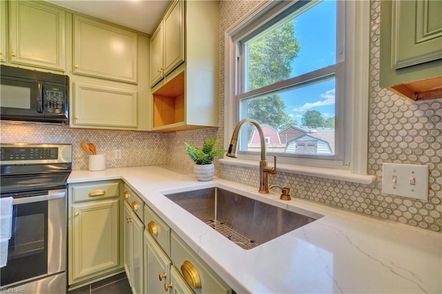 529 Warren Ave, Chesapeake, VA 23322 - kitchen featuring stainless steel range with electric cooktop, black microwave, a sink, green cabinets, and decorative backsplash