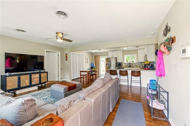 7413 Doummar Dr, Norfolk, VA 23518 - living room featuring dark wood-style floors, ceiling fan, baseboards, and a textured wall