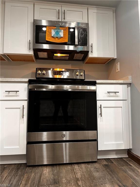 1013 River Birch Ct, Chesapeake, VA 23320 - kitchen with appliances with stainless steel finishes, light countertops, white cabinetry, and dark wood-style flooring
