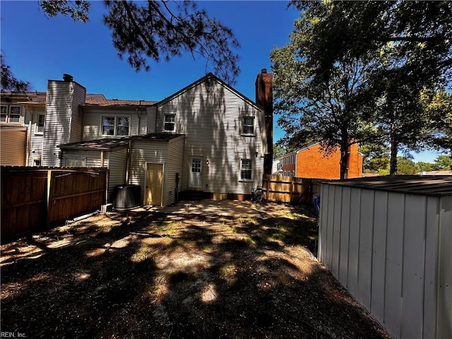 1013 River Birch Ct, Chesapeake, VA 23320 - rear view of property featuring a chimney, a fenced backyard, and central air condition unit