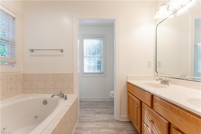 3711 Goodwin Neck Rd, Yorktown, VA 23692 - full bath with double vanity, a tub with jets, toilet, and baseboards