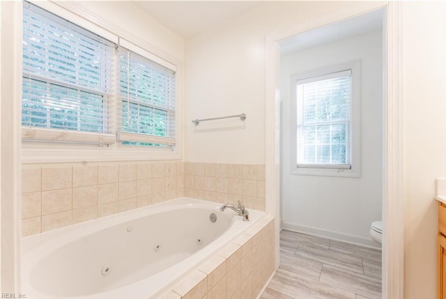 3711 Goodwin Neck Rd, Yorktown, VA 23692 - bathroom featuring vanity, a whirlpool tub, toilet, and baseboards