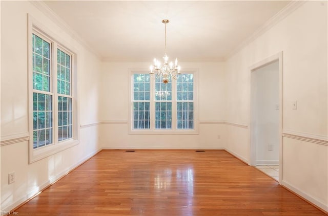 3711 Goodwin Neck Rd, Yorktown, VA 23692 - empty room with plenty of natural light, a chandelier, crown molding, and wood finished floors