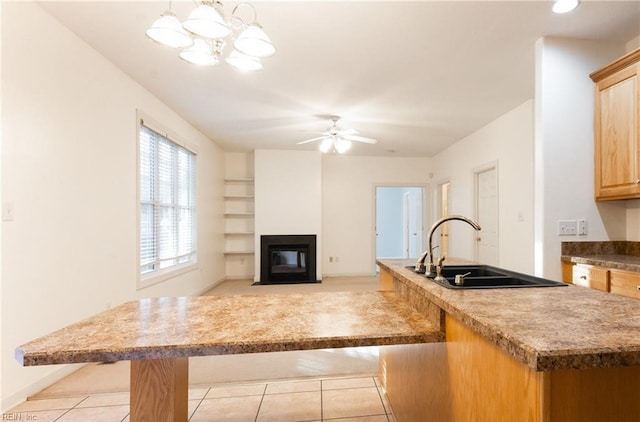 3711 Goodwin Neck Rd, Yorktown, VA 23692 - kitchen featuring a sink, a chandelier, a center island with sink, a ceiling fan, and built in shelves
